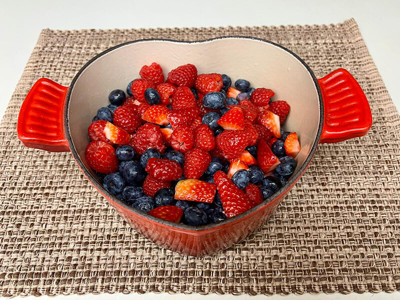 berries in pot making compote